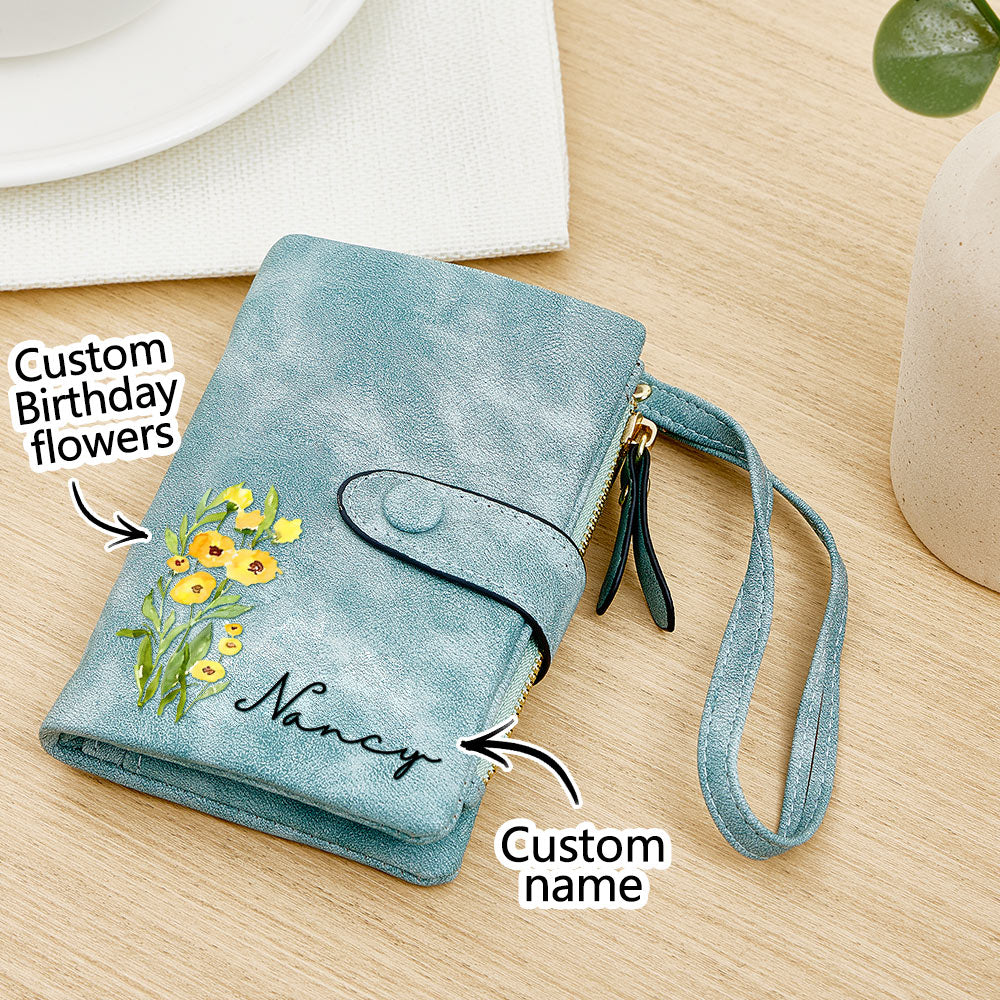 Custom birth flower leather wallet with personalized name – Elegant blue leather wallet with floral engraving, wrist strap, and zippered pocket – Thoughtful and unique birthday gift for her.